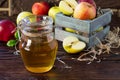 Fresh fruity apple juice and ripe apples on a wooden table. The concept of nutrition for superfoods and health or detoxification