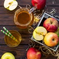 Fresh fruity apple juice and ripe apples on a wooden table. The concept of nutrition for superfoods and health or detoxification.