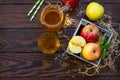 Fresh fruity apple juice and ripe apples on a wooden table. The concept of nutrition for superfoods and health or detoxification.