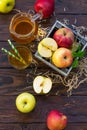 Fresh fruity apple juice and ripe apples on a wooden table. The concept of nutrition for superfoods and health or detoxification.