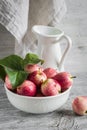 Fresh garden apples in a white bowl, vintage enameled pitcher