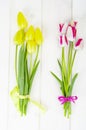 Fresh garden multicolored tulips on white wooden table