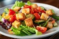 Fresh Garden Salad With Croutons Served on a White Plate in a Casual Dining Setting Royalty Free Stock Photo