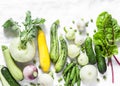 Fresh garden seasonal vegetables - kohlrabi, zucchini, squash, cucumbers, chard, green peas, onions, garlic on a light background, Royalty Free Stock Photo