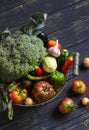 Fresh garden vegetables - broccoli, zucchini, eggplant, peppers, beets, tomatoes, onions, garlic - in vintage metal basket Royalty Free Stock Photo