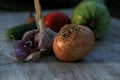 Fresh garden vegetables - garlic, onion, zucchini, tomatoes, cucumber on a light wooden background Royalty Free Stock Photo