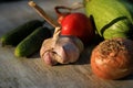 Fresh garden vegetables - garlic, onion, zucchini, tomatoes, cucumber on a light wooden background Royalty Free Stock Photo