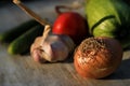 Fresh garden vegetables - garlic, onion, zucchini, tomatoes, cucumber on a light wooden background Royalty Free Stock Photo