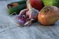 Fresh garden vegetables - garlic, onion, zucchini, tomatoes, cucumber on a light wooden background Royalty Free Stock Photo