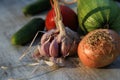 Fresh garden vegetables - garlic, onion, zucchini, tomatoes, cucumber on a light wooden background Royalty Free Stock Photo