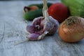 Fresh garden vegetables - garlic, onion, zucchini, tomatoes, cucumber on a light wooden background Royalty Free Stock Photo