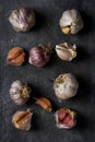 Fresh garlic bulbs and cloves grouped on black background Royalty Free Stock Photo