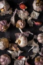 Fresh garlic bulbs and cloves grouped on black background Royalty Free Stock Photo