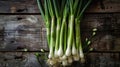 Fresh garlic bulbs with green scapes on dark background. Close-up food photography