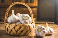 Fresh Garlic Bulbs in a Rustic Wicker Basket on a Wooden Table Royalty Free Stock Photo