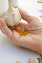 Fresh garlic head and capsules of garlic oil Royalty Free Stock Photo