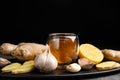 Fresh garlic and other natural cold remedies on grey table Royalty Free Stock Photo