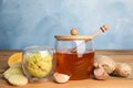 Fresh garlic and other natural cold remedies on wooden table Royalty Free Stock Photo