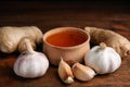 Fresh garlic and other natural cold remedies on table Royalty Free Stock Photo