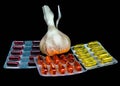 Fresh garlic , pills and vitamins in blister packs Royalty Free Stock Photo