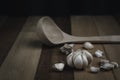 Fresh garlic on the wood background and blurred spoon food concept