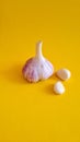 Fresh garlic on a yellow background. Royalty Free Stock Photo