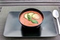 Fresh gazpacho tomato soup on black plate