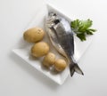 A fresh gilthead bream with potatoes and parsley on a plate 5 Royalty Free Stock Photo