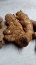 Fresh ginger placed on wooden plank background. Selective focus.