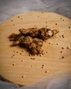 Fresh ginger root and coriander seeds on a wooden cutting board on a white abstract background. Royalty Free Stock Photo