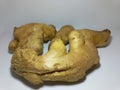 Fresh ginger root resting on a clean white surface. Royalty Free Stock Photo