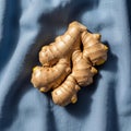 Of fresh ginger root (Zingiber officinale) rests on a light blue Royalty Free Stock Photo