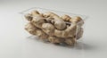 Fresh Ginger Roots in Clear Plastic Container on White Background Royalty Free Stock Photo