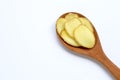 Fresh ginger slices on wooden spoon on white background Royalty Free Stock Photo