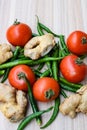 Fresh Ginger, Tomato and green chili pepper on plain wooden table, green essential vegetables for all essential foods, view of Royalty Free Stock Photo