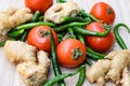 Fresh Ginger, Tomato and green chili pepper on plain wooden table, green essential vegetables for all essential foods, view of Royalty Free Stock Photo