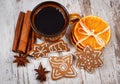 Fresh gingerbread, cup of coffee and spices on old wooden background, christmas time Royalty Free Stock Photo