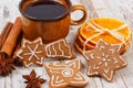 Fresh gingerbread, cup of coffee and spices on old wooden background, christmas time Royalty Free Stock Photo