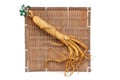 Fresh ginseng root on bamboo basket with green leaves and berries Royalty Free Stock Photo