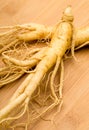 Fresh Ginseng on the wooden background Royalty Free Stock Photo