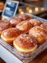 Fresh glazed donuts in a box at a bakery display shelf. Royalty Free Stock Photo
