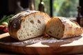 A fresh, golden-brown loaf of bread sits atop a sturdy wooden cutting board, perfect for slicing and serving., A slice of organic Royalty Free Stock Photo