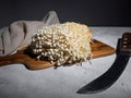Fresh golden needle mushroom or enoki mushrooms, on wooden cutting board with vintage knife on gray concrete background Royalty Free Stock Photo