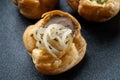 Fresh golden profiterole with pate. Gourmet cuisine, decorated with onions.