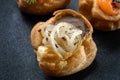 Fresh golden profiterole with pate. Gourmet cuisine, decorated with onions.