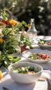 A fresh, gourmet salad graces an elegant outdoor dining setup.. AI Generated