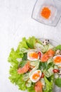 Fresh gourmet salad with red salmon caviar and eggs and vegetables. Protein luxury delicacy healthy food. beautifull served