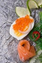 Fresh gourmet salad with salmon, caviar, eggs and vegetables. Protein luxury delicacy healthy food. beautifull served around