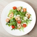 Fresh gourmet seafood salad with shrimps, greens, cherry tomatoes, cheese