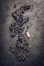 Fresh grape, cork and corkscrew on dark background Royalty Free Stock Photo
